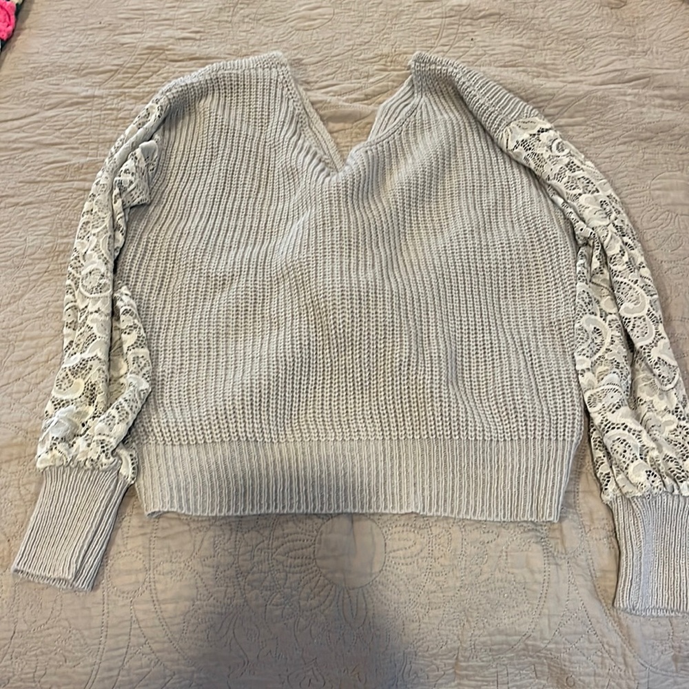 Reversible gray sweater with lace sleeve detailing and crossover back